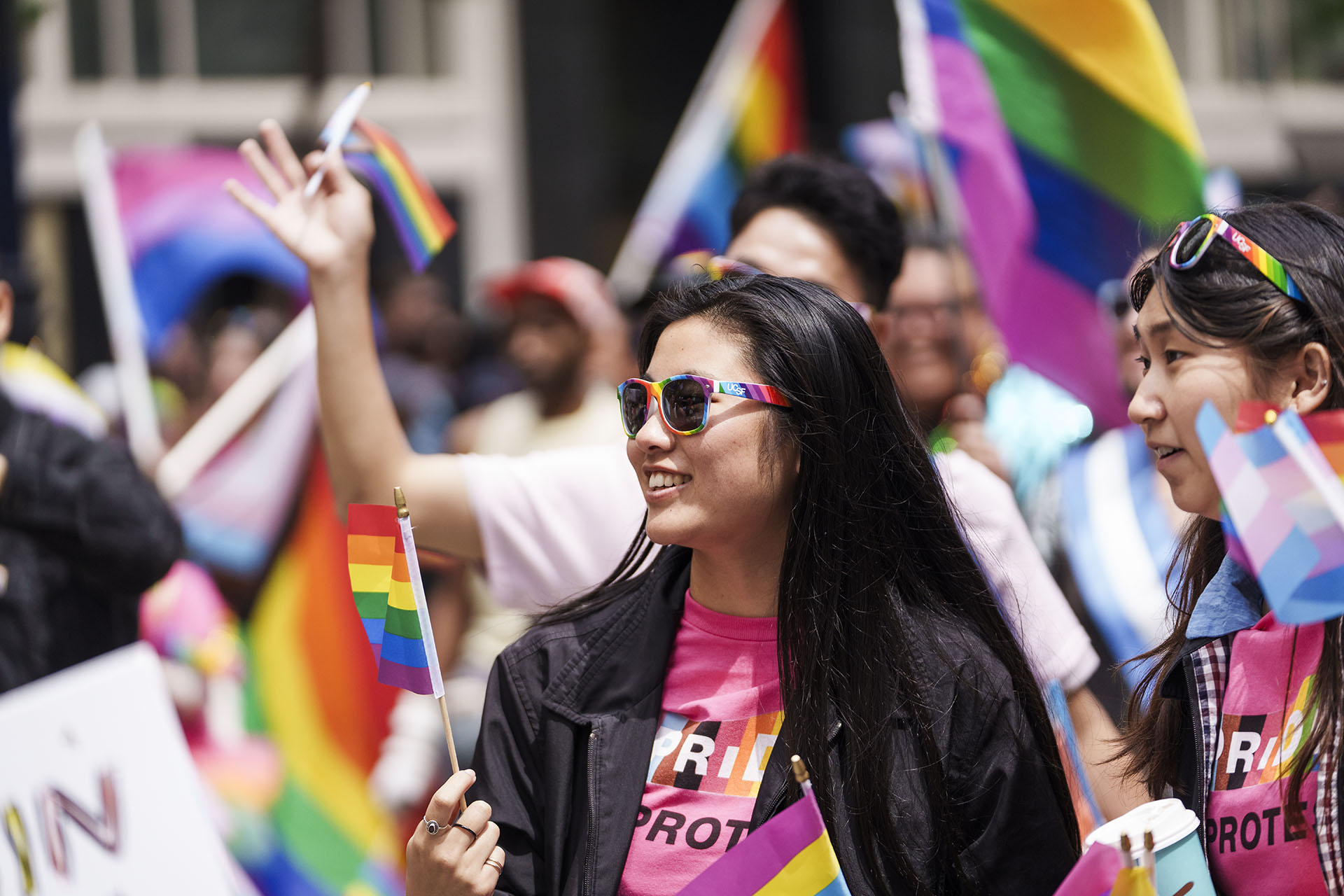 Two UCSF community members participate in the 2023 San Francisco Pride parade.